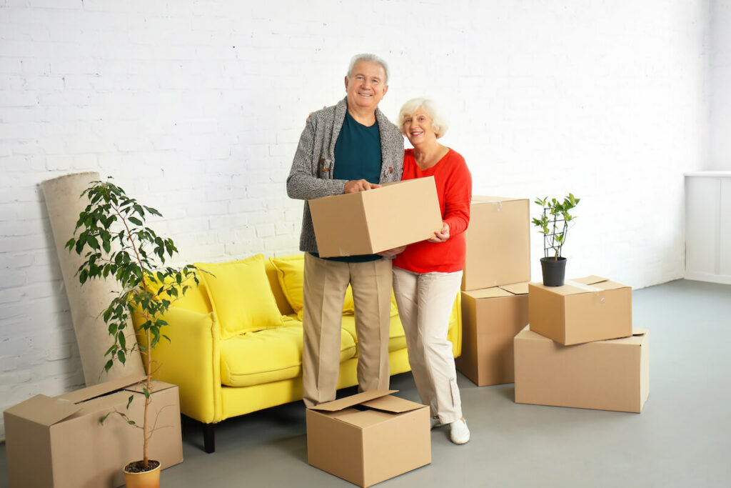 Sage Oak of Lake Charles | Happy senior couple standing around moving boxes