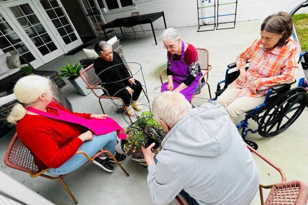 Sage Oak of Lake Charles | Senior memory care residents gardening together