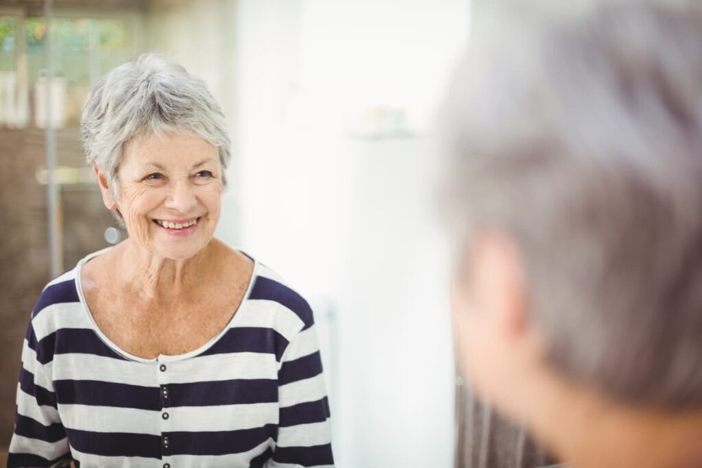 Sage Oak of Lake Charles | Woman Looking In Bathroom Mirror