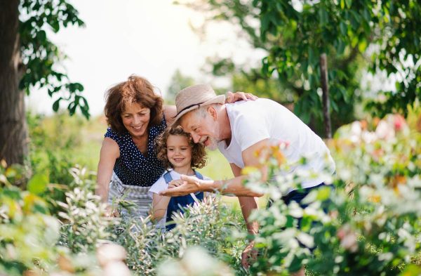 Sage Oak of Lake Charles | Senior man in garden with his daughter and granddaughter